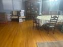 Spacious living room with hardwood floors, a large window, and a dining table at 404 E Kentucky Ave, Deland, FL 32724