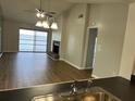 Open-concept living room with a fireplace, wood floors, and expansive views of the lake at 4109 Fairview Vista Pt # 315, Orlando, FL 32804