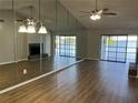 Spacious living room features wood floors, fireplace, mirrored wall, and lake views at 4109 Fairview Vista Pt # 315, Orlando, FL 32804