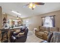 Open-concept living room featuring tile floors, neutral walls, and comfortable seating at 4561 Heritage Oak Dr, Orlando, FL 32808