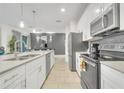 Bright kitchen featuring stainless steel appliances, granite countertops, and ample cabinet space at 4983 Windermere Ave, Kissimmee, FL 34746