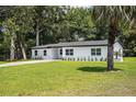 Well-manicured lawn surrounds this cozy home, creating an inviting curb appeal and a lovely outdoor space at 50 Community Dr, Debary, FL 32713