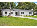 A neat front yard enhances this home's appeal, offering a glimpse of its inviting atmosphere and cozy charm at 50 Community Dr, Debary, FL 32713