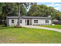This home boasts a lovely facade, a tidy front yard, and a welcoming entrance, blending comfort and style at 50 Community Dr, Debary, FL 32713