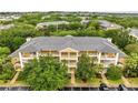 Aerial view showcasing the well-maintained complex, lush trees, and manicured landscaping at 510 Rum Run # 33 510, Davenport, FL 33837