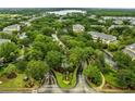 Aerial view of the manicured neighborhood landscaping, mature trees, and community roads at 510 Rum Run # 33 510, Davenport, FL 33837