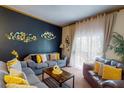 Comfortable living room area with a dark accent wall, curtains, and cozy couches at 510 Rum Run # 33 510, Davenport, FL 33837