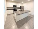 Modern kitchen featuring white cabinets, stainless steel appliances, and granite countertops at 5168 Greenheart Ave, Mount Dora, FL 32757