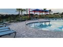 Inviting community pool with ample seating and shaded areas at 707 Staffora St, Haines City, FL 33844