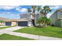 Stunning gray home with green lawn and palm trees, enhancing its curb appeal at 726 Lake Biscayne Way, Orlando, FL 32824
