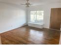 Bright living room features hardwood floors, a ceiling fan, and a large window at 766 Canovia Ave, Orlando, FL 32804