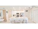 Bright kitchen with large island, stainless steel appliances and white cabinets at 853 Bocavista Ct, Davenport, FL 33896
