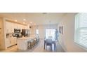 Open concept kitchen with stainless steel appliances and island breakfast bar at 853 Bocavista Ct, Davenport, FL 33896