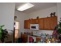 Functional kitchen with wooden cabinetry, white appliances, and ample counter space at 8564 Bay Lilly Loop, Kissimmee, FL 34747