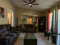 Comfortable living room features neutral walls, a ceiling fan, and plenty of natural light, perfect for relaxation at 909 Royalton Rd, Orlando, FL 32825