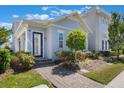 Beautiful home exterior with landscaped yard and walkway leading to an inviting front door with glass at 9443 Merrifield St, Orlando, FL 32827