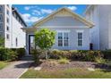 Inviting home featuring a well-kept lawn, garden, and a welcoming front entrance with a clear door at 9443 Merrifield St, Orlando, FL 32827