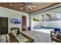 Covered patio area featuring tile floors, outdoor dining, a ceiling fan, and access to the pool at 9743 Covent Garden Dr, Orlando, FL 32827