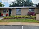 Charming exterior view highlighting landscaping and a quaint facade at 207 Esplanade Way # 101, Casselberry, FL 32707