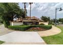 Well-maintained entrance to Curzon Place featuring lush landscaping and elegant signage at 10533 Belfry Cir, Orlando, FL 32832
