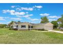 Well-kept one-story home with a green lawn and attached two-car garage in a residential neighborhood at 10980 Sw 62Nd Ave, Ocala, FL 34476