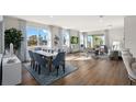 Bright and airy living room with large windows, modern furnishings, and wood flooring at 13216 Pergola Ave, Orlando, FL 32832