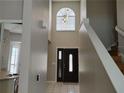Bright entryway featuring tile flooring and a staircase at 1668 Spicewood Ln, Casselberry, FL 32707