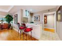 Stylish bar area with seating, a wet bar, and views into the living spaces at 21 Abbey Ct, Haines City, FL 33844
