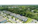 Lovely aerial view of homes nestled in a lush green community with a scenic lake nearby at 2159 Marsh Sedge Ln, Winter Park, FL 32792