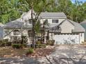 Charming two-story home featuring stone accents, a well-manicured lawn, and a two-car garage at 220 Wimbledon Cir, Lake Mary, FL 32746