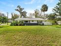 Picture of the home's front exterior showing a luscious green lawn at 2205 Pine Island Dr, New Smyrna Beach, FL 32168