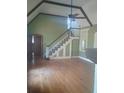 Inviting living room with hardwood floors, staircase, and natural light at 2603 E Lake Hartridge Dr, Winter Haven, FL 33881