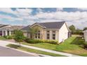 Attractive single-Gathering home with a manicured lawn, tidy landscaping and a grey roof at 2604 Meadowedge Loop, St Cloud, FL 34772