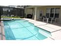 Inviting screened-in pool area with attached jacuzzi and outdoor seating at 2605 Daulby St, Kissimmee, FL 34747