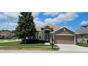Charming single-story home with a well-manicured lawn and attached two-car garage at 2752 Bellewater Pl, Oviedo, FL 32765