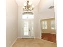 Bright foyer with high ceilings, tile flooring, and a decorative chandelier at 2752 Bellewater Pl, Oviedo, FL 32765