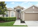 Charming home featuring a well-manicured lawn and a two car garage at 2752 Bellewater Pl, Oviedo, FL 32765