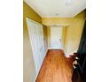 Inviting entryway with wood-look tile flooring, closet, and white front door at 276 Celebration Blvd, Celebration, FL 34747