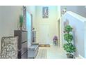 Welcoming entryway with high ceilings, neutral tile flooring, and decorative accents at 2783 Red Horse Dr, Kissimmee, FL 34744