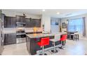 Kitchen with granite counters, stainless steel appliances, and seating at the island at 2783 Red Horse Dr, Kissimmee, FL 34744