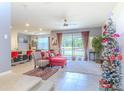 Open-concept living room with large windows, ceiling fan, and view of the backyard at 2783 Red Horse Dr, Kissimmee, FL 34744