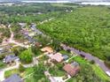A beautiful aerial view highlighting waterfront access, lush greenery, and the serene neighborhood at 28136 Tammi Dr, Tavares, FL 32778