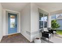 Inviting front porch with seating area, decorative rug, and stylish front door at 3294 Hanging Tide St, Winter Garden, FL 34787