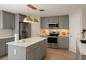 Beautiful kitchen featuring stainless steel appliances, light grey cabinetry, and a center island at 358 Fairfield Dr, Sanford, FL 32771