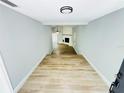 Bright entryway and living room with wood floors, and white brick fireplace at 412 Editha Cir, Sanford, FL 32771