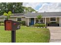 Exterior of home with green lawn and mailbox in front, a blue front door with glass and house number above at 417 Carvell Dr, Winter Park, FL 32792