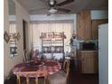 Eat-in dining space shows a round table, shelf for dishes and a ceiling fan at 442 Fanfair Ave, Orlando, FL 32811