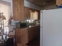 Galley kitchen includes wood cabinets, a microwave and a double-basin sink at 442 Fanfair Ave, Orlando, FL 32811