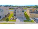 Two-story home with attached two-car garage, beautiful landscaping and backyard pond view at 4432 Seven Canyons Dr, Kissimmee, FL 34746