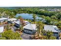 Exterior view of condos with ground floor garages and screened in second story patios overlooking mature trees at 4465 Ring Neck Rd # C, Orlando, FL 32808